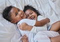 Brothers and sisters separated by distance joined by love. a brother and sister laying in bed at home. Royalty Free Stock Photo