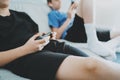 Brothers sitting on a sofa in living room and playing video games. Family relaxing time at home concept. Royalty Free Stock Photo