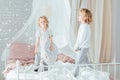 Brothers standing on bed Royalty Free Stock Photo