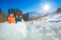 Brothers throw snowballs in the snow fortress, over mountains Royalty Free Stock Photo