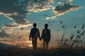 Brothers walking through a field at sunset, showing affection in silhouette Royalty Free Stock Photo