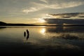 Brothers in the water of a big lake at sunset Royalty Free Stock Photo