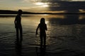 Brothers in the water of the Lake at sunset Royalty Free Stock Photo