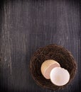 broun broken egg shells in the nest on wooden surface Royalty Free Stock Photo
