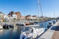 Brouwershaven, Zeeland, Netherlands. April 26, 2021. Harbor pier with boats anchored over calm waters Royalty Free Stock Photo