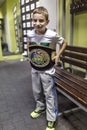 Brovary. Ukraine, 14.11.2015 a smiling little boy is trying on a champion boxing belt