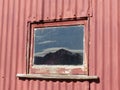 Brow Peak mountain reflected in barn window