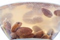 Almond kernels soaked in water close-up, delicious macro