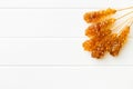Brown amber sugar crystal on wooden stick. Royalty Free Stock Photo
