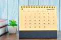 The Brown August 2023 Monthly desk calendar for the organizer to plan 2023 year with the books on wooden table