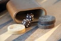 Brown backgammon dice and pieces on wooden game board