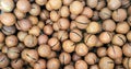 Brown background of delicious macadamia nuts.