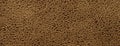 Brown background from a soft upholstery textile material, closeup Royalty Free Stock Photo