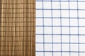 Brown bamboo mat on table cloth with blue grid pattern. Royalty Free Stock Photo