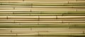Brown bamboo sticks arranged in a pattern on a rectangle grille wall Royalty Free Stock Photo