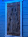 Brown barn window on blue building Royalty Free Stock Photo