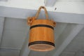 A brown barrel hanging on the white wooden ceiling