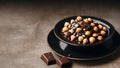 Brown beans and chocolate in a bowl, a delicious and healthy snack with coffee Royalty Free Stock Photo