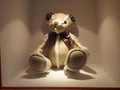 Brown bear and white lace bear doll, sitting quietly on the display stand, the light shining on the bear