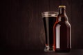 Brown beer bottle belgian steinie and glass pilsner with porter on dark wood board, copy space, mock up. Royalty Free Stock Photo