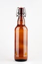 Brown beer bottle with bugle plug isolated on white background. Royalty Free Stock Photo