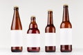 Brown beer bottles collection different type with blank white label on white wooden board, mock up.