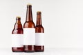 Brown beer bottles collection different type with blank white label on white wooden board, mock up.