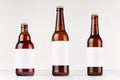 Brown beer bottles collection different type with blank white label on white wooden board, mock up.