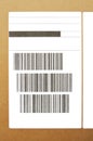 Brown and beige cardboard paper mail envelope on sticky barcodes