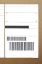 Brown and beige cardboard paper mail envelope on sticky barcodes