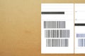 Brown and beige cardboard paper mail envelope on sticky barcodes