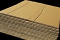 Brown and beige corrugated cardboard detail, isolated on black background Royalty Free Stock Photo