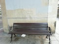 A brown bench is along the sideway. Royalty Free Stock Photo