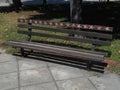 Brown bench painted in little red and white seashells