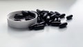 Black pill on white isolated with plastic caps and bottles Royalty Free Stock Photo