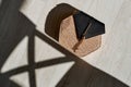 a brown-black wicker bag lies on a white floor with a bright sun and shadows Royalty Free Stock Photo