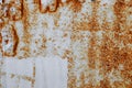 Brown, black and yellow rust and dirt on white enamel. Rusted brown and white abstract texture. Corroded white metal background.