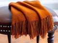 A brown blanket sitting on top of a brown stool Royalty Free Stock Photo