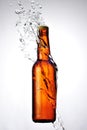 Brown bottle of beer and a water splash Royalty Free Stock Photo