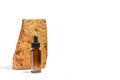 A brown bottle with a dropper in front of a piece of brick Royalty Free Stock Photo