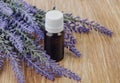 Organic essential oil in bottle and lavender flowers on wooden Royalty Free Stock Photo