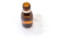 Brown bottle with medical mixture and medicine measuring cup