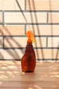 Brown bottle for sunblock spray or tanning oil spray Royalty Free Stock Photo