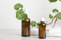 Brown bottles with aroma oils,white towels,plant on marble table at the bathroom Royalty Free Stock Photo