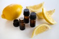 Brown bottles of lemon essential oils with fresh lemons Royalty Free Stock Photo