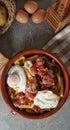 a brown bowl filled with french fries and bacon eggs next to a basket Royalty Free Stock Photo