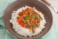 A brown bowl of white rice with stir fry beef with Royalty Free Stock Photo