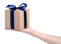 Brown box with blue ribbon bow gift in hand Royalty Free Stock Photo