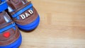 Brown boy`s shoes with blue soles and little red heart and word dad