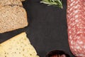 Brown bread, dutch gouda cheese and meat on slate board Royalty Free Stock Photo
